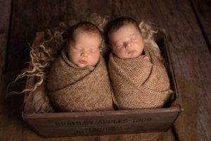 Newborn Photographer Medway Twin Newborn Boys wrapped in biscuit coloured wraps in a crate